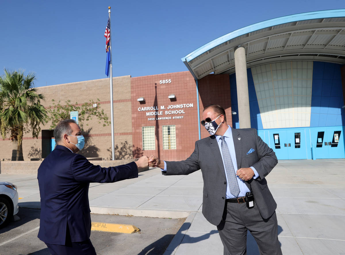 Johnston Middle School Principal Louis Markouzis, right, greets Clark County School District Su ...