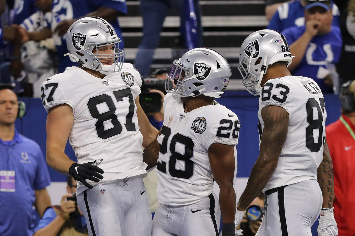 Oakland Raiders tight end Foster Moreau (87) celebrates his touchdown score with running back J ...