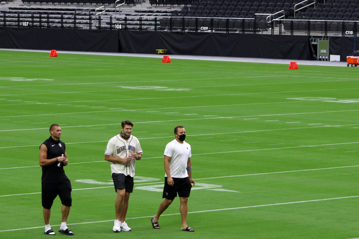 Derek Carrier, Foster Moreau and Alec Ingold walk on the field prior to a Las Vegas Raiders tea ...
