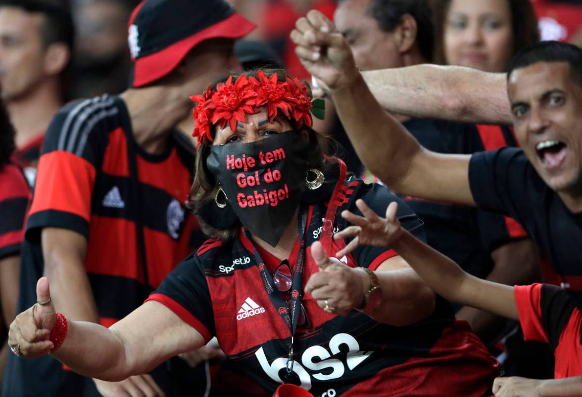 A fan of Brazil's Flamengo uses a mask before a Copa Libertadores soccer match against Ecuador' ...