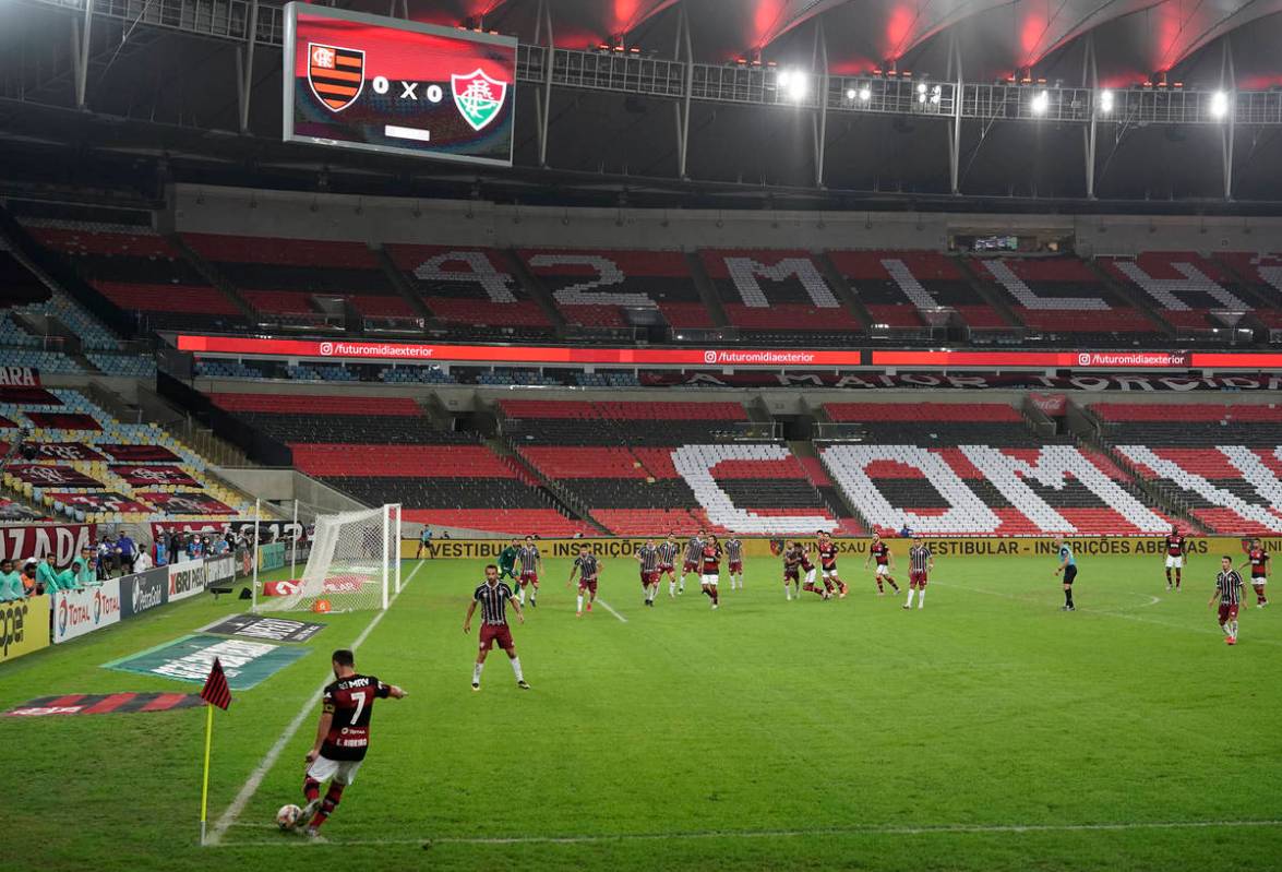 Flamengo's Everton Ribeiro, left, kicks the ball during the Rio de Janeiro state championship f ...