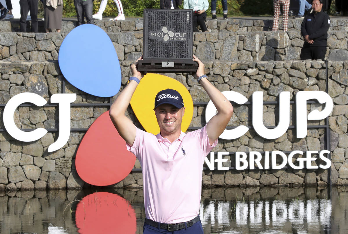 Justin Thomas of the United States holds up his trophy after winning the CJ Cup PGA golf tourna ...