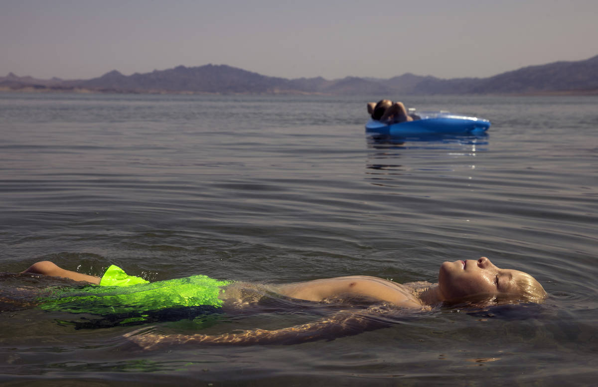 Lucas School, 10, of Glenwood Springs, Colo., floats with his mom Nicole at Boulder Beach about ...