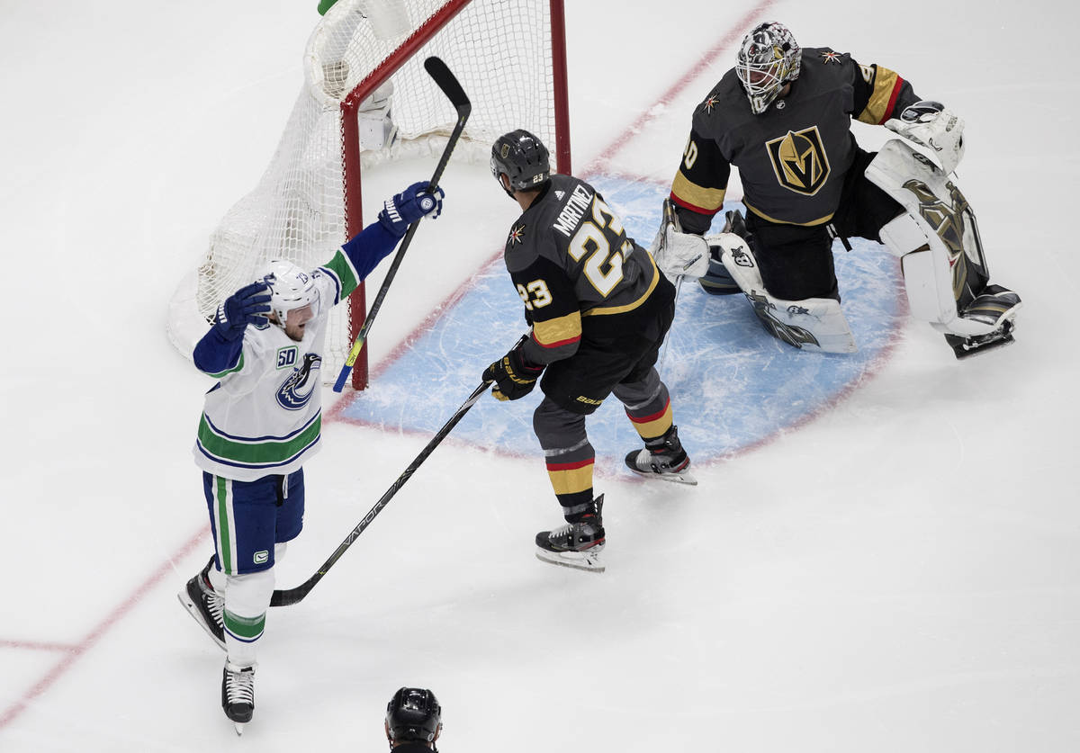 Vegas Golden Knights goalie Robin Lehner (90) is scored on as Vancouver Canucks' Alexander Edle ...