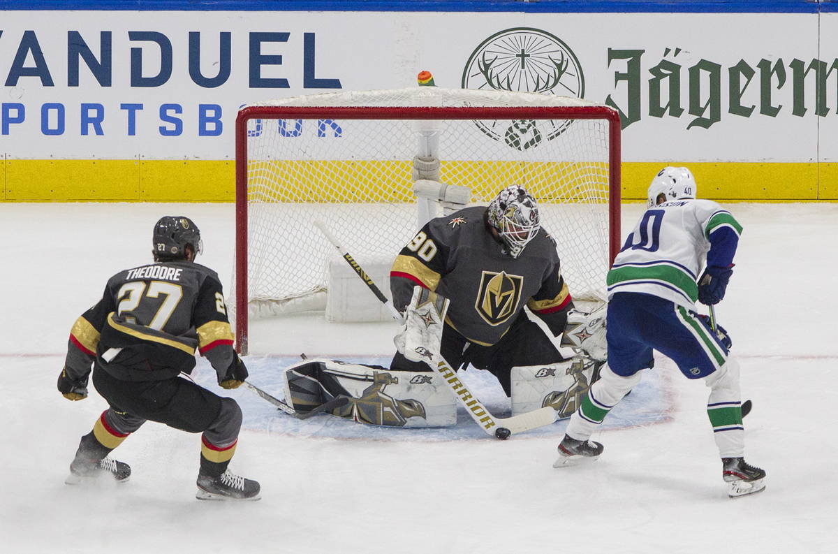 Vegas Golden Knights' goalie Robin Lehner (90) makes the save on Vancouver Canucks' Elias Pette ...