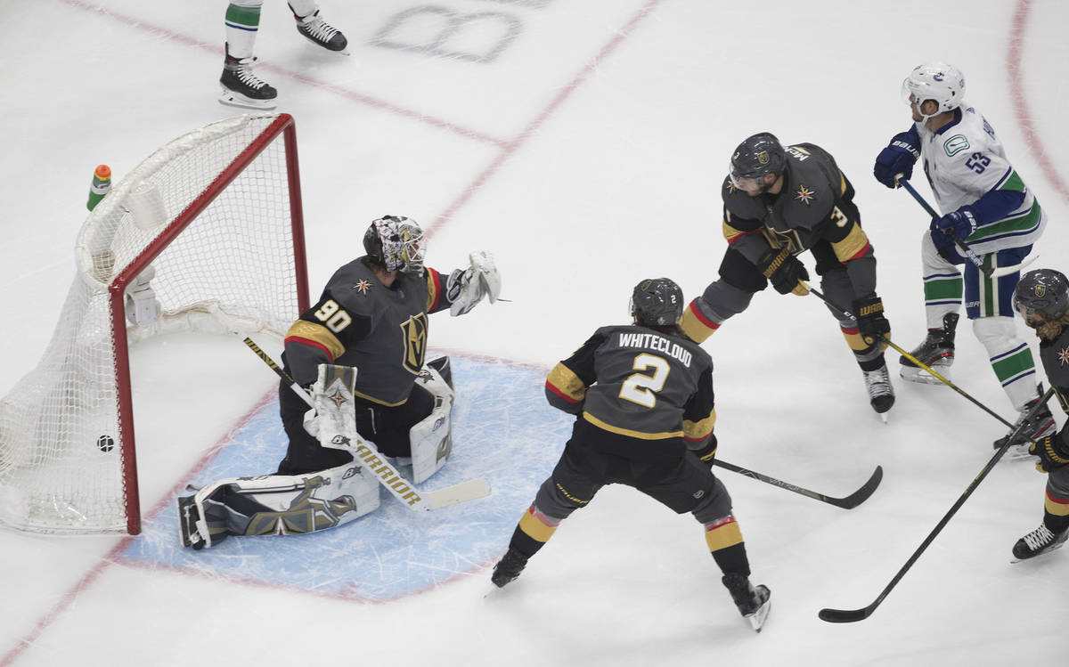 Vegas Golden Knights goalie Robin Lehner (90) is scored on by Vancouver Canucks' Bo Horvat (53) ...