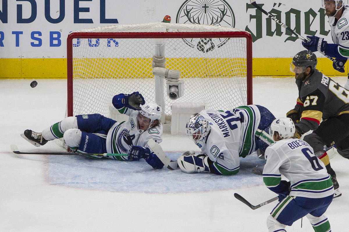 Vegas Golden Knights' Max Pacioretty (67) looks for the puck as Vancouver Canucks' Troy Stecher ...