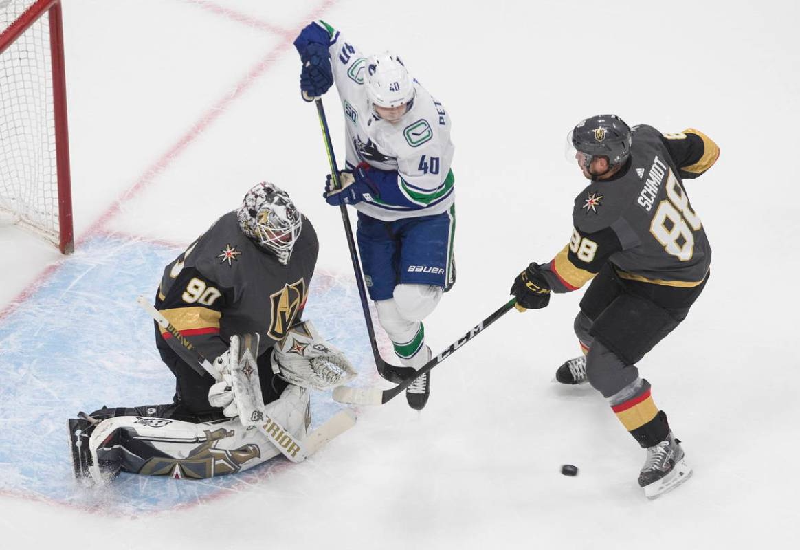 Vegas Golden Knights' goalie Robin Lehner (90) makes the save as Vancouver Canucks Elias Petter ...