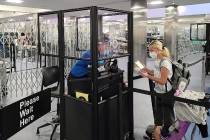 Acrylic barriers have been installed in security checkpoints at McCarran International Airport ...