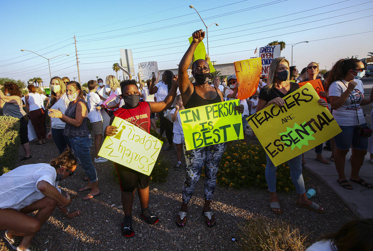 Shelly Davis, center, with her son, James Davis, 12, participates in a demonstration in support ...