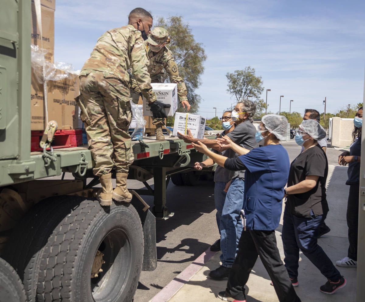 The Nevada National Guard unloads boxes of personal protective equipment to Silver Hills Health ...