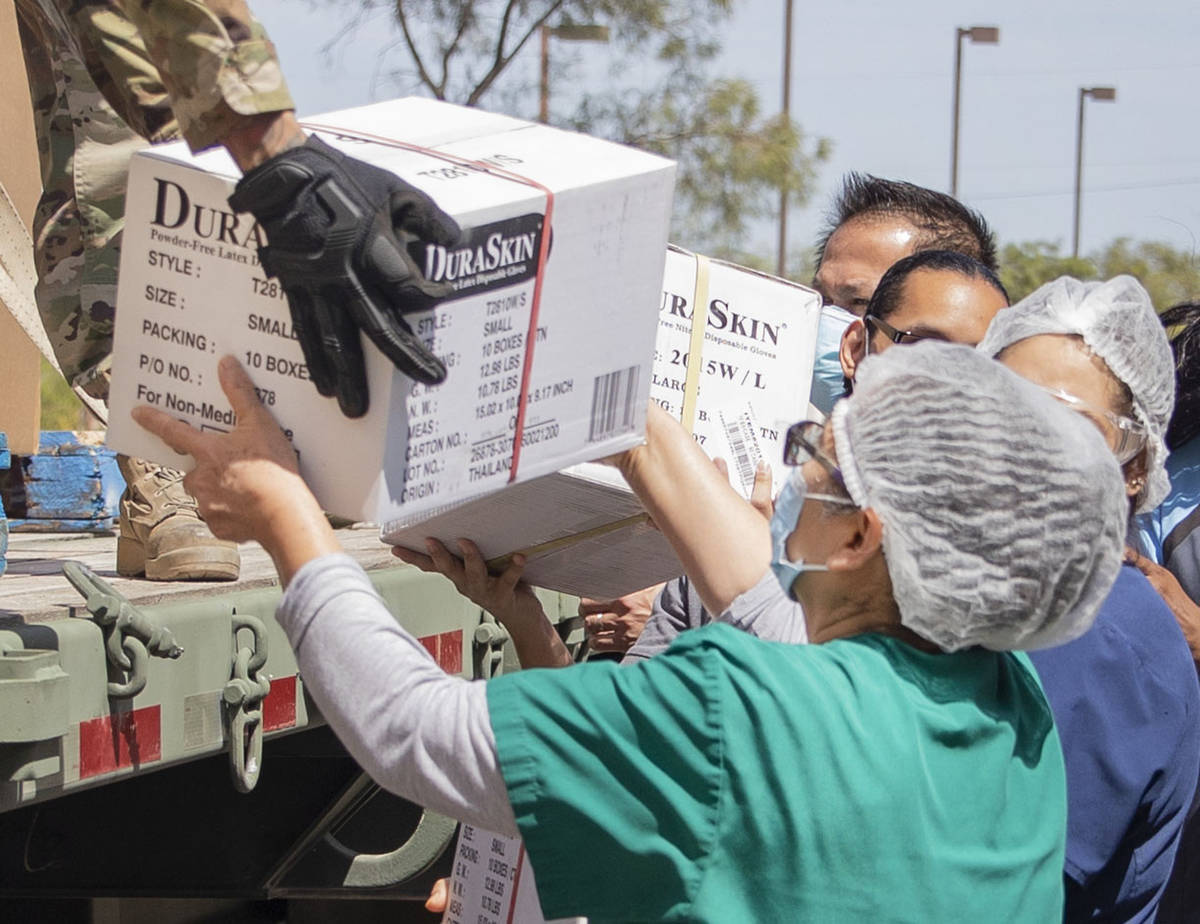 Staff of Silver Hills Health Care Center help unload boxes of personal protective equipment fro ...