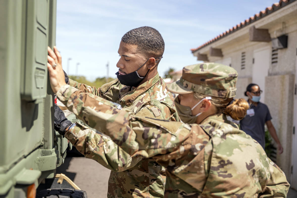 Nevada National Guard specialist Donshay Watkins, left, and Sgt. Vanessa Gonzales unload person ...