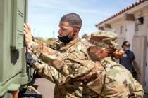 Nevada National Guard specialist Donshay Watkins, left, and Sgt. Vanessa Gonzales unload person ...