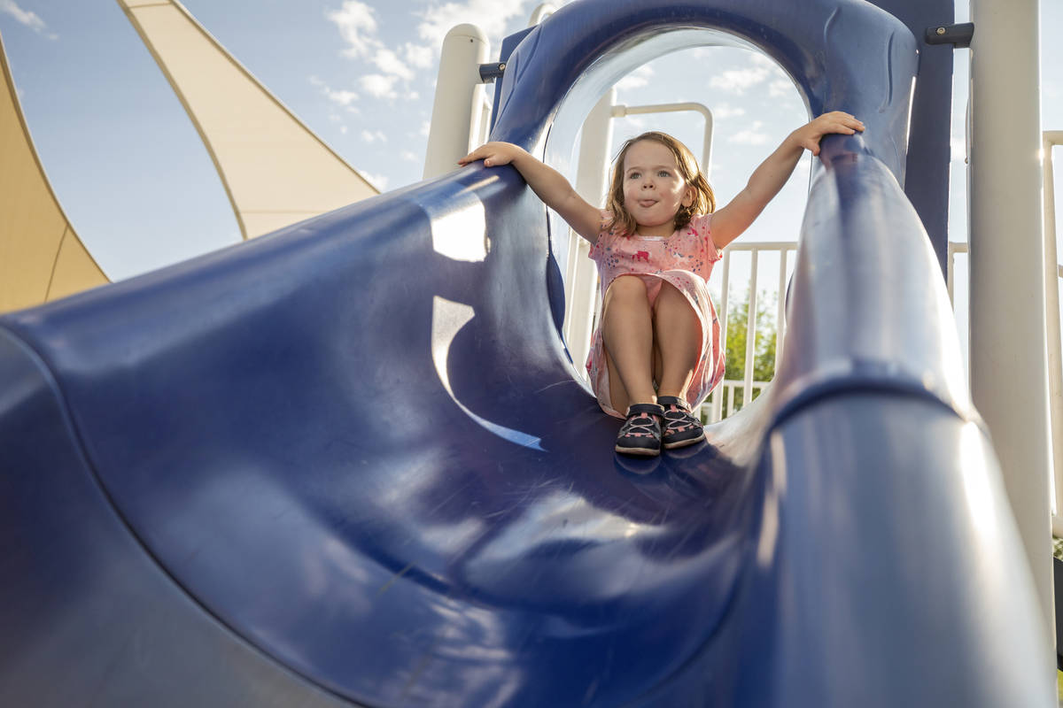 Clara Sandberg, 4, goes down a slide at Siena Heights Trailhead Park in Henderson on Friday mor ...