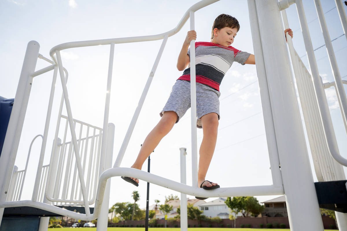 Robert Sandberg, 10, climbs a jungle gym at Siena Heights Trailhead Park in Henderson on Friday ...