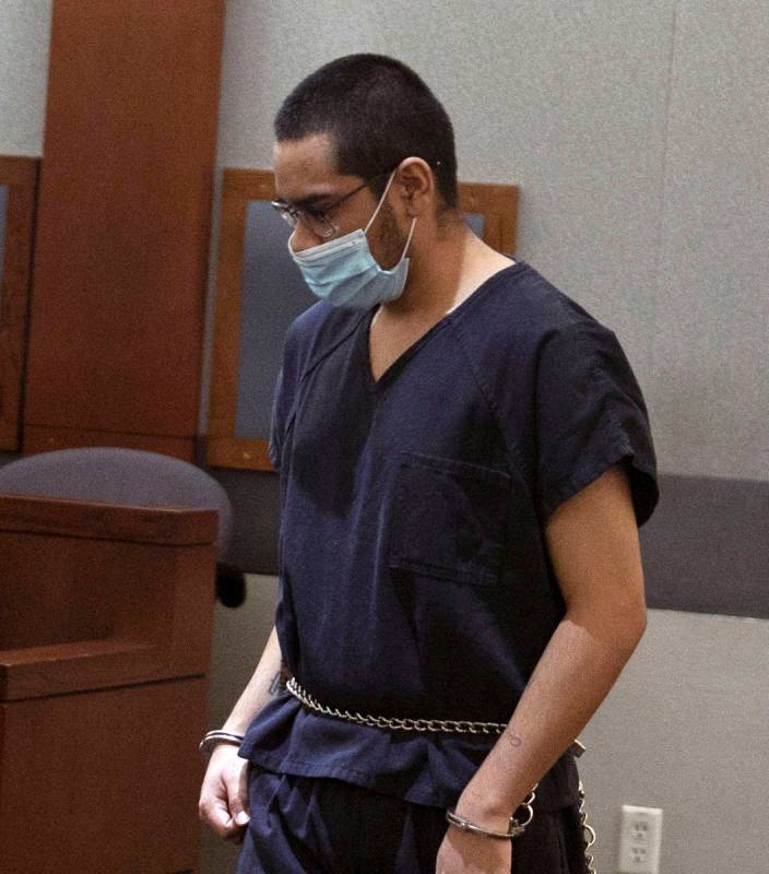 Edgar Samaniego, charged in the shooting of a Las Vegas police officer, is led into the courtro ...