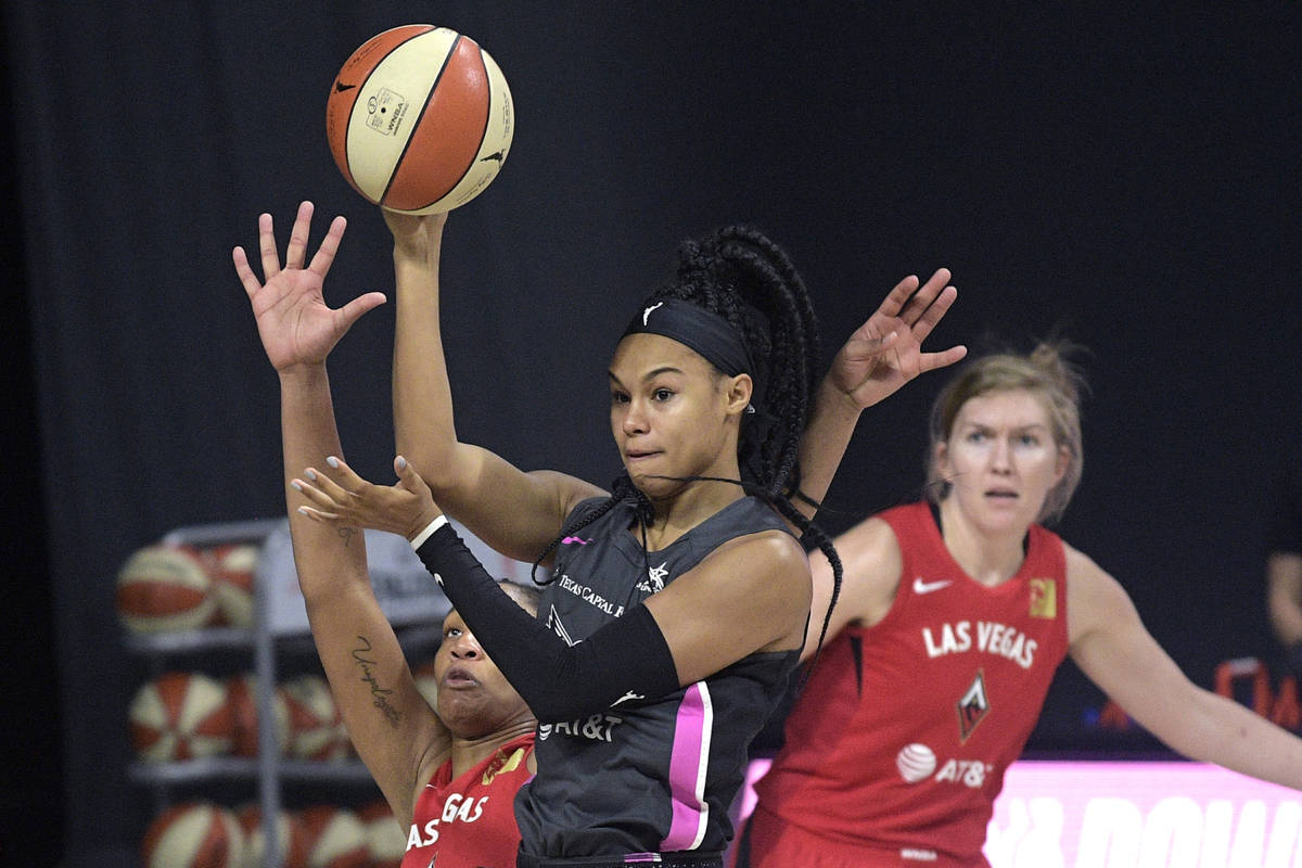 Dallas Wings forward Satou Sabally passes the ball in front of Las Vegas Aces center A'ja Wilso ...