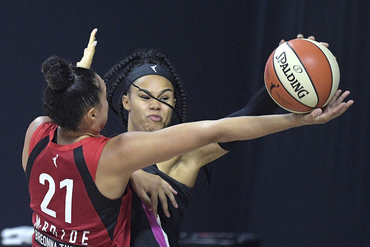Dallas Wings forward Satou Sabally blocks a shot by Las Vegas Aces guard Kayla McBride (21) dur ...