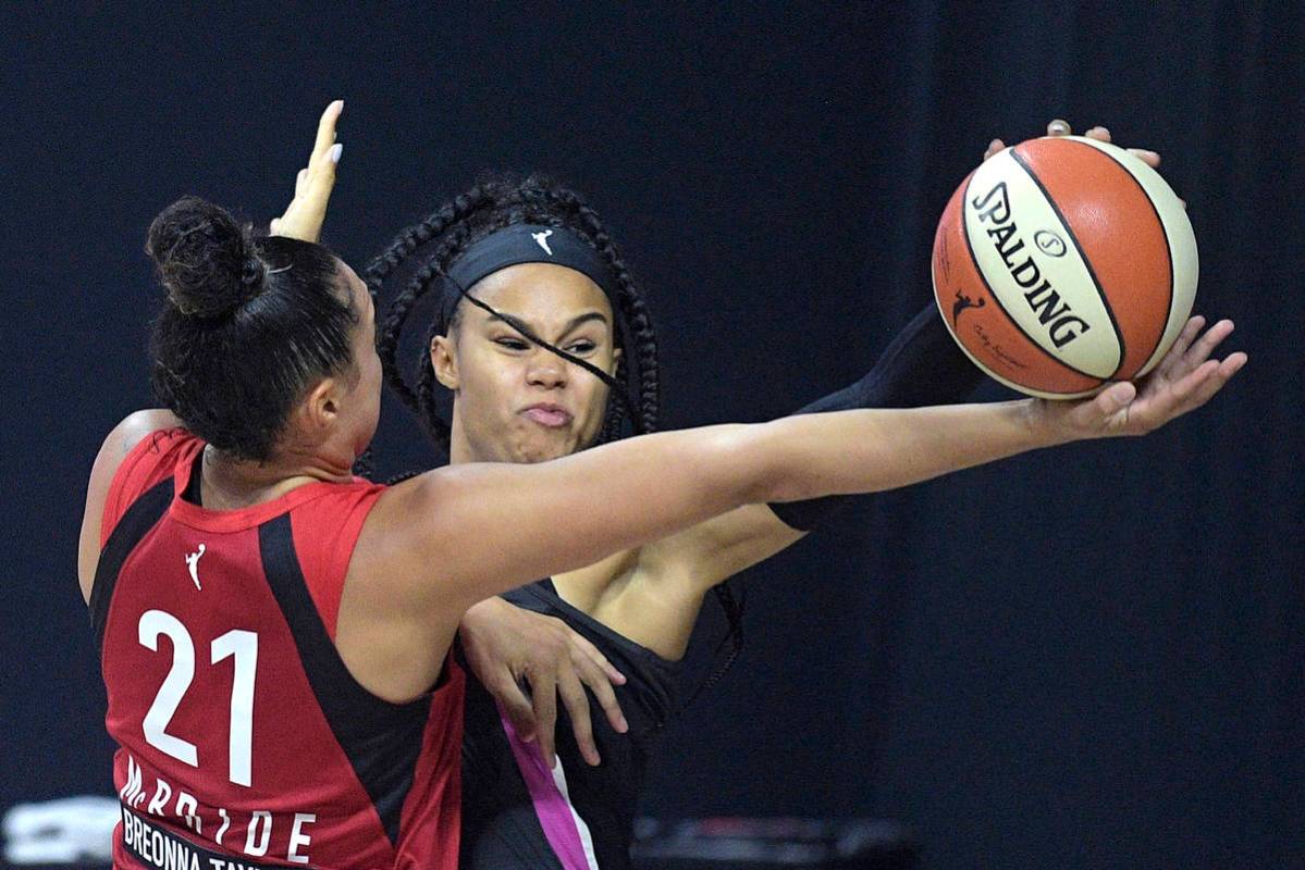 Dallas Wings forward Satou Sabally blocks a shot by Las Vegas Aces guard Kayla McBride (21) dur ...