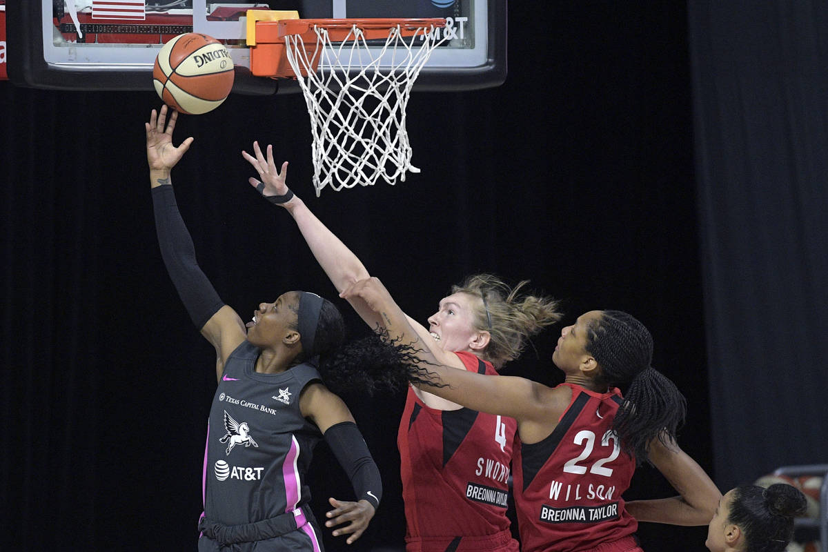 Dallas Wings guard Arike Ogunbowale (24) goes up for a shot in front of Las Vegas Aces center C ...