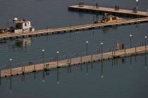 A couple walks along a dock at the Lake Mead Marina about the Lake Mead National Recreation Are ...