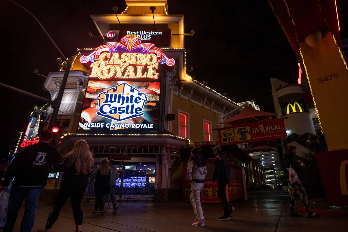 People walk past Casino Royale on the Strip on Tuesday, March 17, 2020, in Las Vegas. (Ellen Sc ...