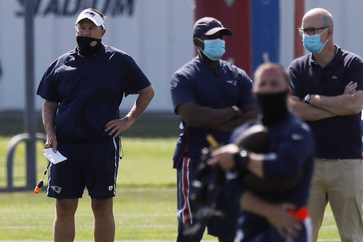 New England Patriots head coach Bill Belichick, left, watches during an NFL football training c ...