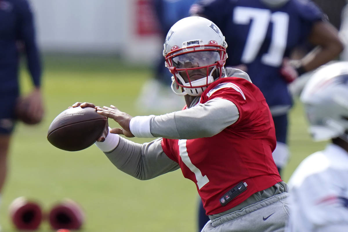 New England Patriots quarterback Cam Newton (1) winds up for a pass during an NFL football trai ...