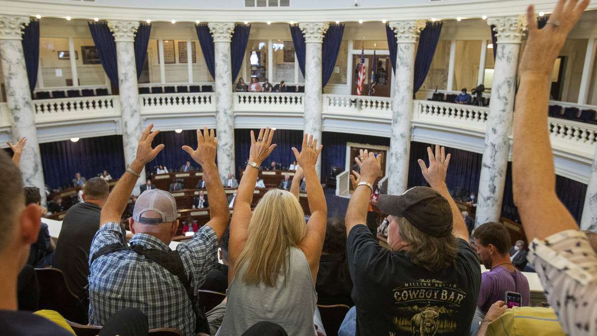 Spectators in the gallery on Tuesday, Aug. 25, in Boise, Idaho, silently indicate their approva ...