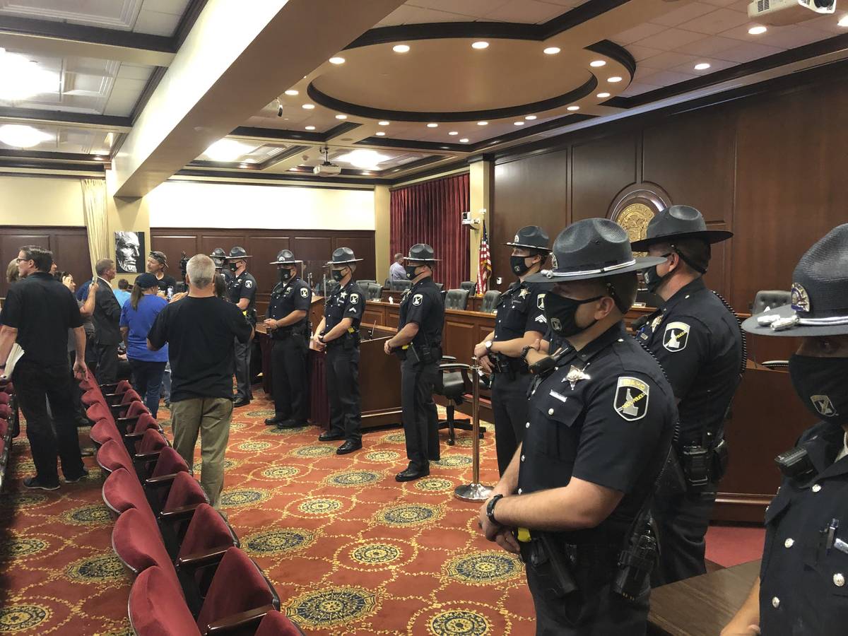 Idaho State Police form a row in a committee meeting room in the Idaho Statehouse in Boise, Ida ...