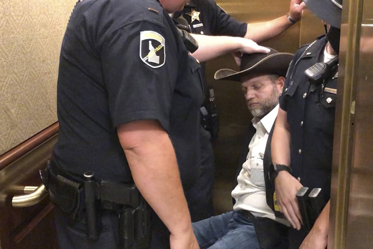 This image taken from video shows anti-government activist Ammon Bundy, rear, being wheeled int ...