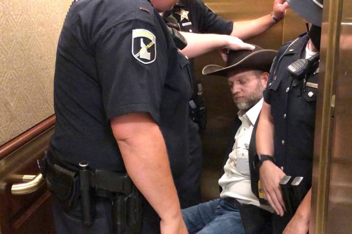This image taken from video shows anti-government activist Ammon Bundy, rear, being wheeled int ...