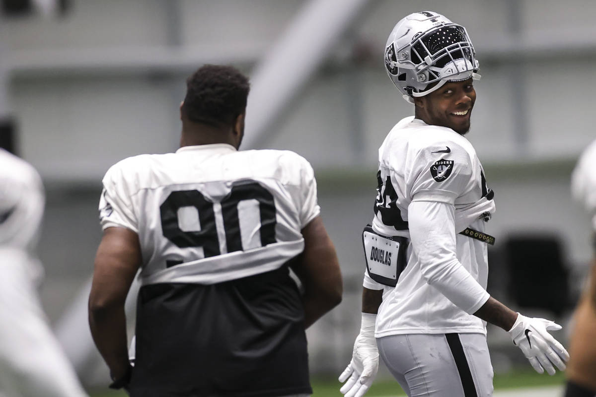Las Vegas Raiders defensive end Arden Key warms up with teammates during an NFL training camp p ...