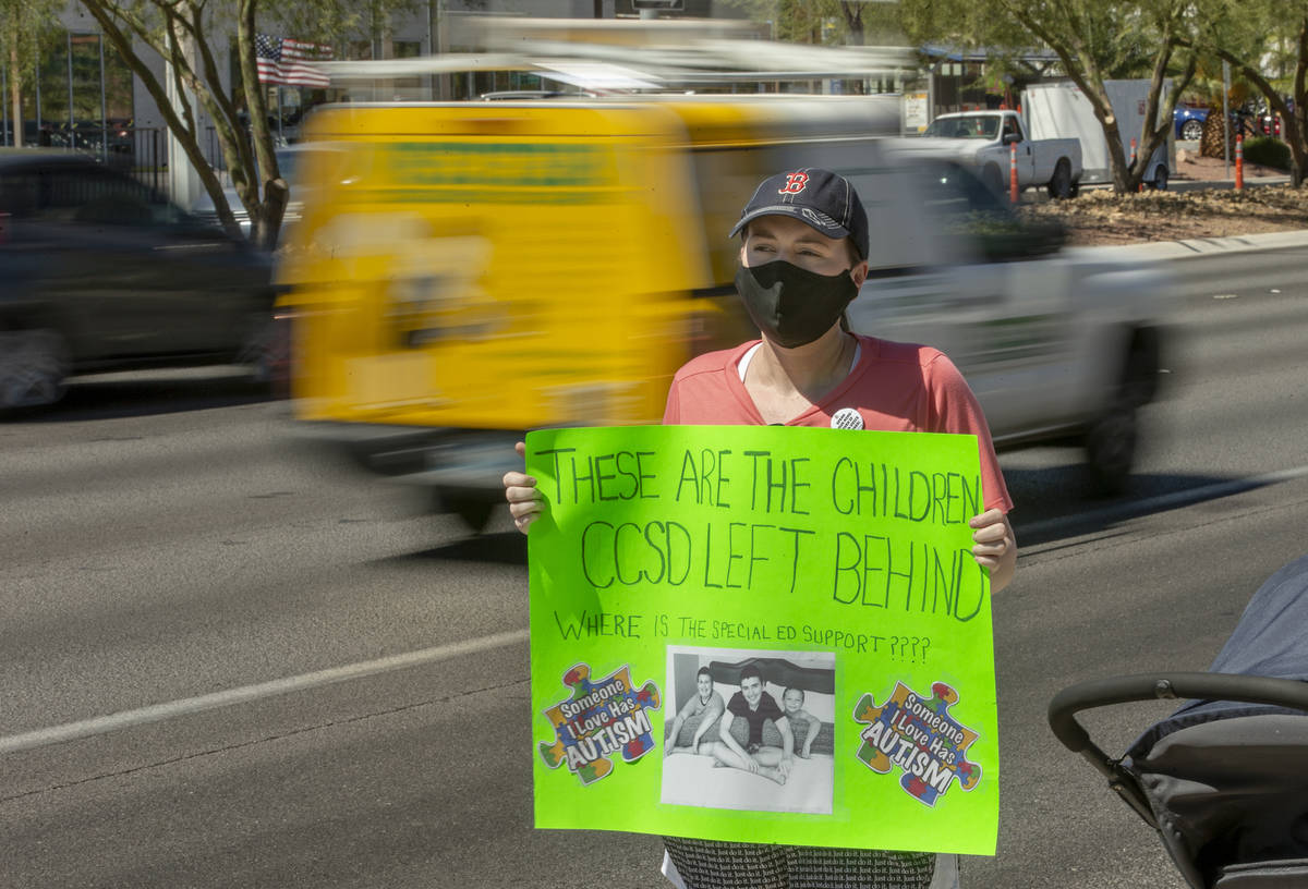 Parent and advocate Diana Battista holds a sign outside the Clark County School District Admini ...