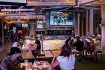 Hockey fans watch the Golden Knights play the Vancouver Canucks during an NHL playoff hockey ga ...