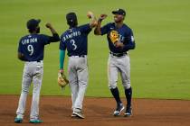 Seattle Mariners center fielder Kyle Lewis, right, celebrates with teammate shortstop J.P. Craw ...
