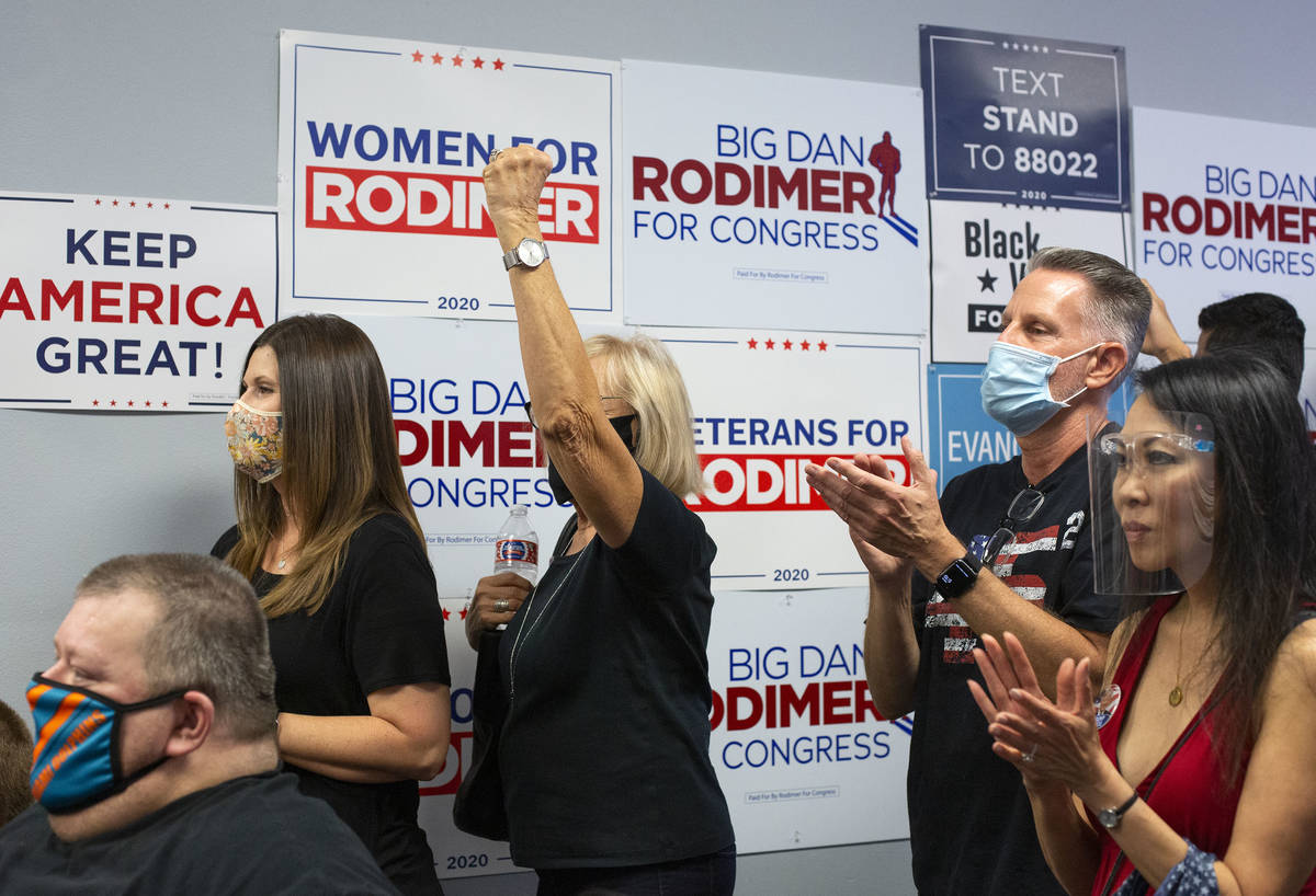Attendees of a Republican National Convention watch party cheer as Dan Rodimer, a Republican ca ...