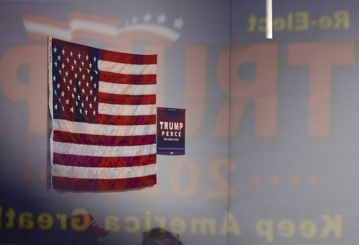 An American Flag and Trump campaign signs adorn the walls at the Trump campaign office in Hende ...