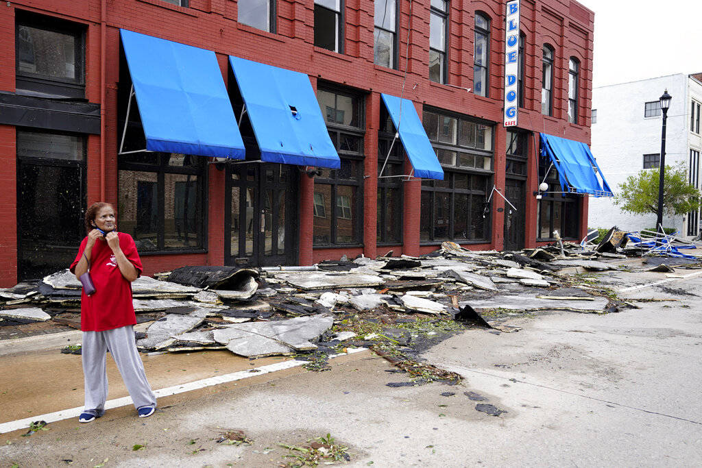 A woman passes on a street near businesses on Thursday, Aug. 27, 2020, in downtown Lake Charles ...