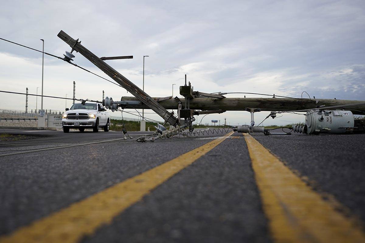 Down power lines stretch across a road in the aftermath of Hurricane Laura Thursday, Aug. 27, 2 ...