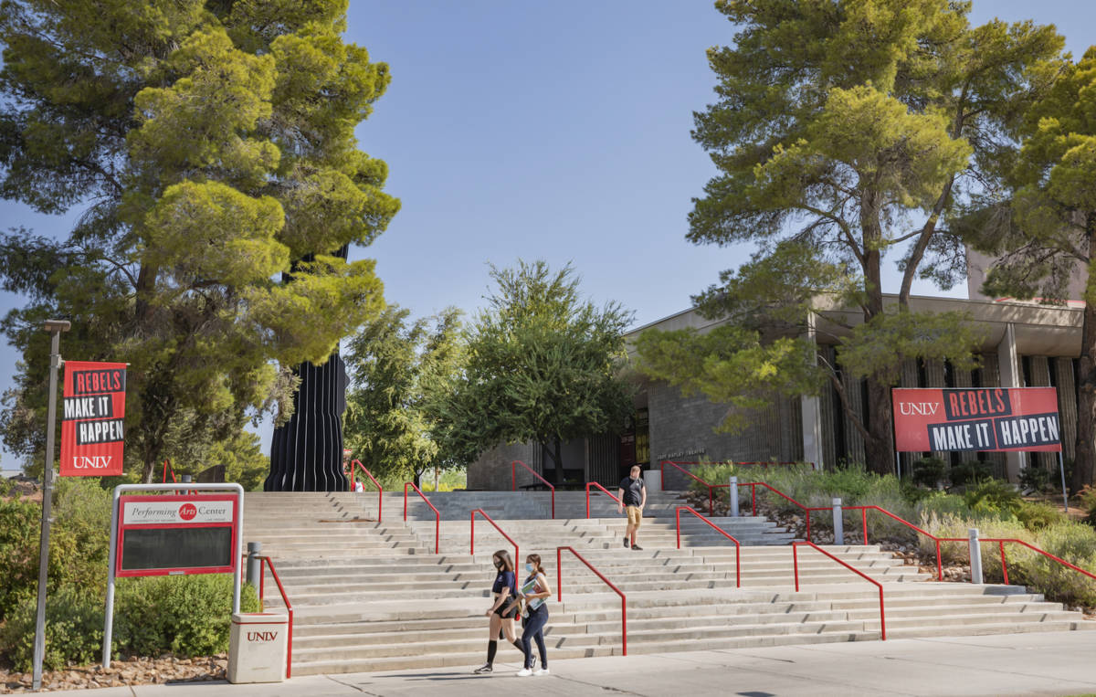 Individuals walk near Artemus W. Ham Concert Hall at UNLV, in Las Vegas on Thursday morning, Au ...