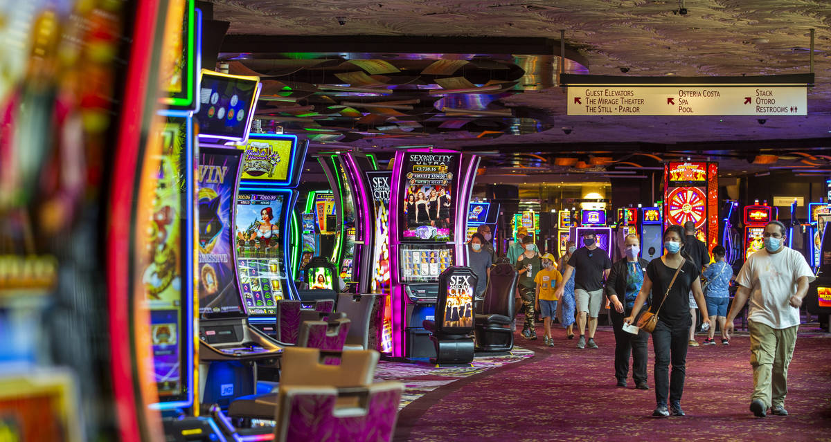 Guests make their way through one of the slots areas as the Mirage reopens following a COVID-19 ...