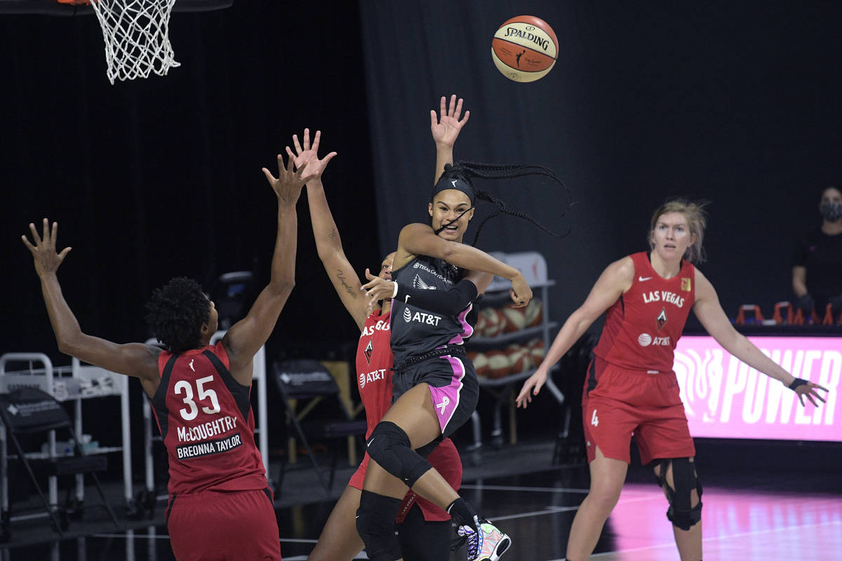 Dallas Wings forward Satou Sabally passes the ball in front of Las Vegas Aces forward Angel McC ...