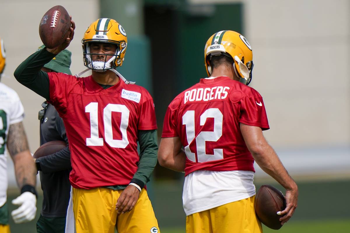 Green Bay Packers' Aaron Rodgers (12) and Jordan Love (10) are seen during NFL training camp Sa ...