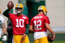 Green Bay Packers' Aaron Rodgers (12) and Jordan Love (10) are seen during NFL training camp Sa ...