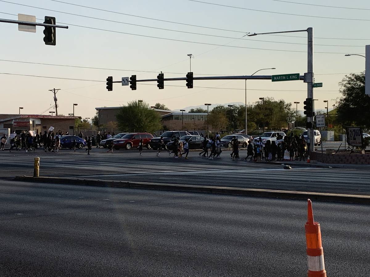 The athletes arrived by marching down Carey Avenue for a peaceful protest at the MLK Statue Thu ...