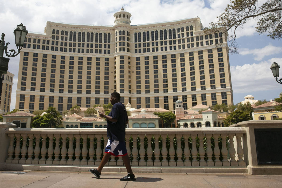 Pedestrian walk past the Bellagio on Friday, Aug. 28, 2020, in Las Vegas. Thousands of MGM Reso ...