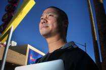Tony Hsieh stands near a Vegas neon sign in downtown Las Vegas on Friday, Feb. 3, 2012. (Jeff S ...