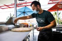 Mimmo Ferraro, owner and chef at Pizza Forte, right, prepares a pizza in the University Gateway ...